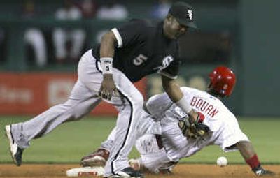 
Chicago White Sox shortstop Juan Uribe attempts a tag against the Phillies.  
 (Associated Press / The Spokesman-Review)