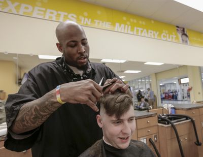 In this May 24, 2017 photo, Seaman Joseph Zyla gets a hair cut from Tyson Sullivan at the barber shop within the Exchange store at Offutt Air Force Base, Neb. (Nati Harnik / Associated Press)