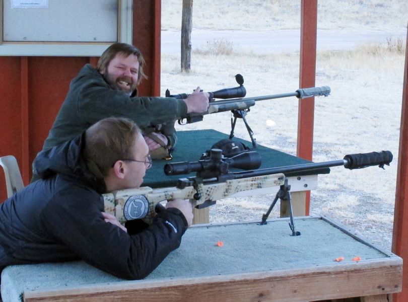 Zak Smith, foreground, and Shane Coppinger, co-owners of Thunder Beast Arms Corp., prepare to shoot high-powered rifles fitted with sound suppressors at a rifle range west of Cheyenne, Wyo., on Wednesday. (Associated Press)