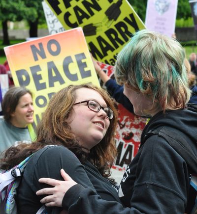 Kittanya Locken and Marly Gilbert, a gay couple, kiss in front of members of the Westboro Baptist Church, who were at the Capitol to protest the state’s same-sex marriage law. (Jim Camden)