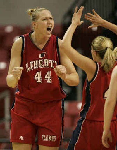 
Liberty's Katie Feenstra, left, reacts after scoring a basket and being fouled during Liberty's 78-70 win over Penn State.
 (Associated Press / The Spokesman-Review)