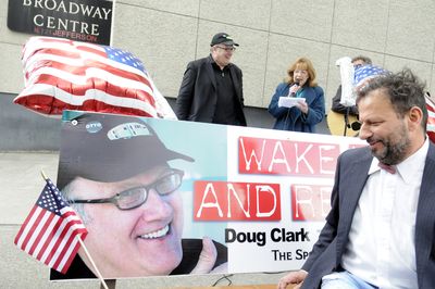 Charlie Schmidt admires Doug Clark’s face while Clark, background, listens to  Spokane City Councilwoman Nancy McLaughlin read a proclamation Thursday.  (Jesse Tinsley / The Spokesman-Review)