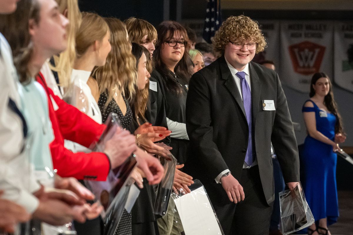 Brayden Martin of Ferris High School steps forward to accepts the first place $5,000 scholarship in Science during the 34th annual Spokane Scholars Foundation awards, Monday, April 20, 2026, at the Spokane Convention Center.  (COLIN MULVANY/THE SPOKESMAN-REVIEW)
