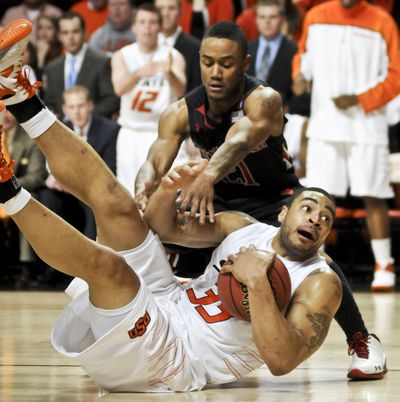 Oklahoma State senior post Marshall Moses, front, averages 14.5 points and 7.4 rebounds a game for the Cowboys this season. (Associated Press)