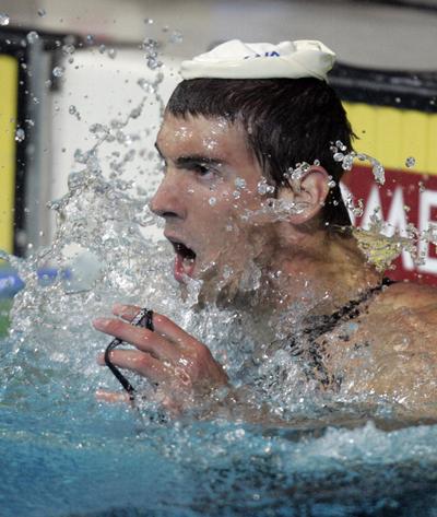 Michael Phelps sees he has set a world record of 50.22 seconds in the 100-meter butterfly at the national championships.  (Associated Press / The Spokesman-Review)