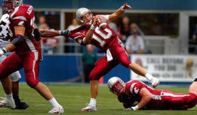 
WSU quarterback Alex Brink is grabbed and pulled down by the long arm of Colorado's Abraham Wright in the second half. The play was typical of Saturday, as WSU's offensive line allowed eight sacks by the Buffaloes. 
 (Christopher Anderson/ / The Spokesman-Review)