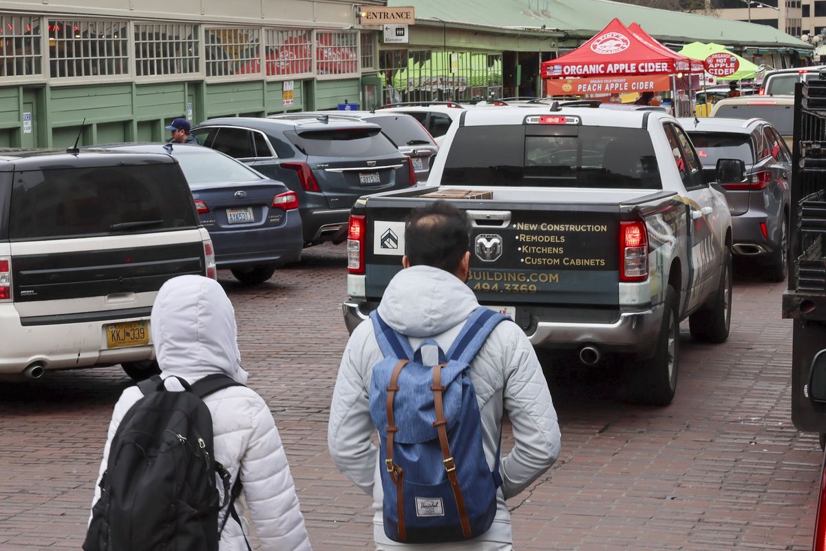 Vehicle and pedestrian traffic Friday morning, Feb. 21, 2025, at Pike Place Market in Seattle. (Kevin Clark/The Seattle Times/TNS)