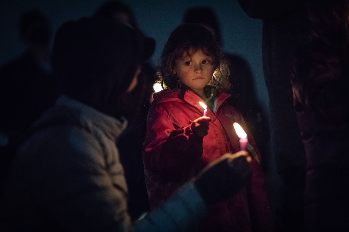 Five-year-old Adaya Christal holds a candle during Chabad of Spokane’s annual menorah lighting for Hanukkah in Riverfront Park on Sunday.  (Libby Kamrowski/ THE SPOKESMAN-REVIEW)