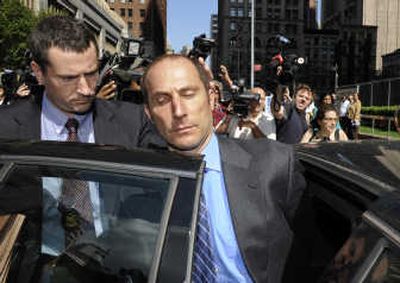 
Federal agents exit 26 Federal Plaza with handcuffed former Bear Stearns hedge fund manager Matthew Tannin, Thursday in New York. Tannin and another ex-manager  are accused of securities fraud in the wake of the collapse of the subprime mortgage market  that foreshadowed Bear Stearns' own demise. Associated Press photos
 (Associated Press photos / The Spokesman-Review)