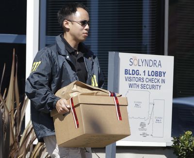 An FBI agent carries a box of evidence from Solyndra headquarters in Fremont, Calif., on Sept. 8. The solar firm received a $535 million loan from the federal government. (Associated Press)