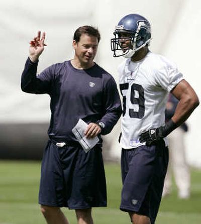 
Jim Mora, with Julian Peterson, brings experience to Seattle. Associated Press
 (Associated Press / The Spokesman-Review)