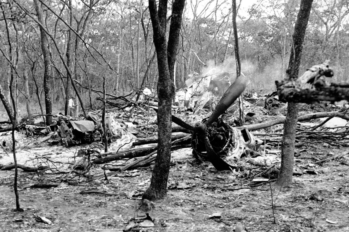 Searchers walk through the scattered wreckage of the DC-6 plane carrying United Nations Secretary-General Dag Hammarskjold in a forest near Ndola, Zambia, on Sept. 19, 1961. Hammarskjold died as he was attempting to bring peace to the newly independent Congo. (Associated Press)