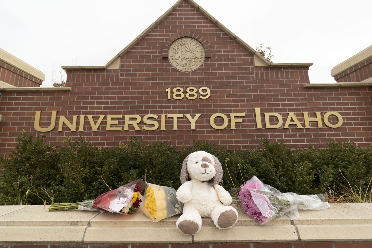 Flowers and a stuffed animal rest next to a University of Idaho sign on Monday on Pullman Road in Moscow.  (Geoff Crimmins/For The Spokesman-Review)