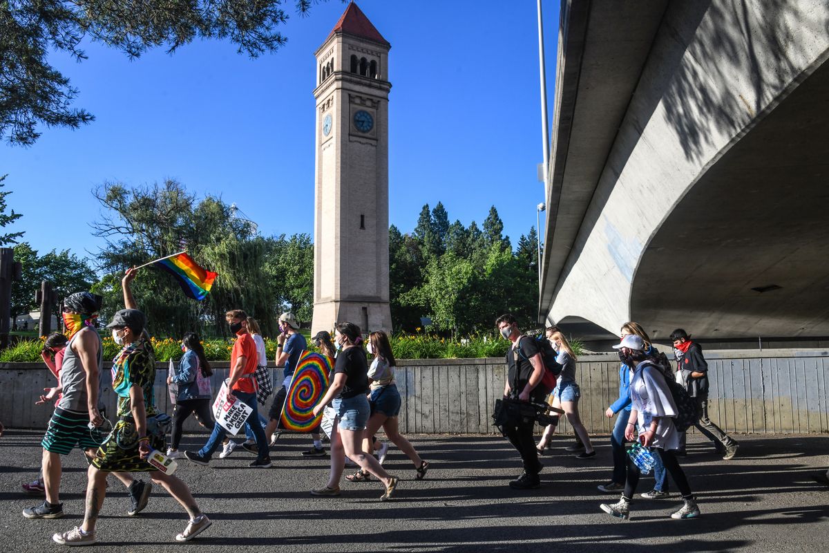 "WE ARE ONE" march participants walk along the Centennial Trail in Riverfront Park, Saturday, June 27, 2020, in Spokane.  (DAN PELLE/THE SPOKESMAN-REVIEW)
