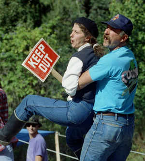 Bill Grider, who lives in the North Idaho area, restrains his wife who is yelling at members of the government forces at the Ruby Ridge standoff in 1992. (SR file photo)