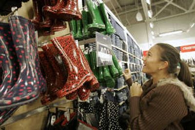 
A shopper looks at discounted rain boots in the Gap store at the Great Mall in Milpitas Calif.
 (The Spokesman-Review)