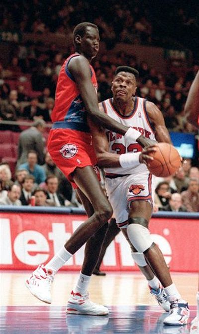 In this Jan. 26, 1993 photo, New York Knicks' Patrick Ewing, right, is  blocked by Philadelphia 76ers' Manute Bol during an NBA game at New York's Madison Square Garden.   Bol has died at a Virginia hospital, where he was being treated for severe kidney trouble and a painful skin condition according to an associate of Bol's. (Jim Sulley / Associated Press)