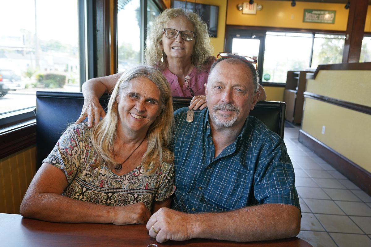 Two days after Debby Neal-Strickland, front left, and Jim Strickland were married in November, Debby donated a kidney to James’ ex-wife Mylaen Merthe, center back.  (John Raoux)