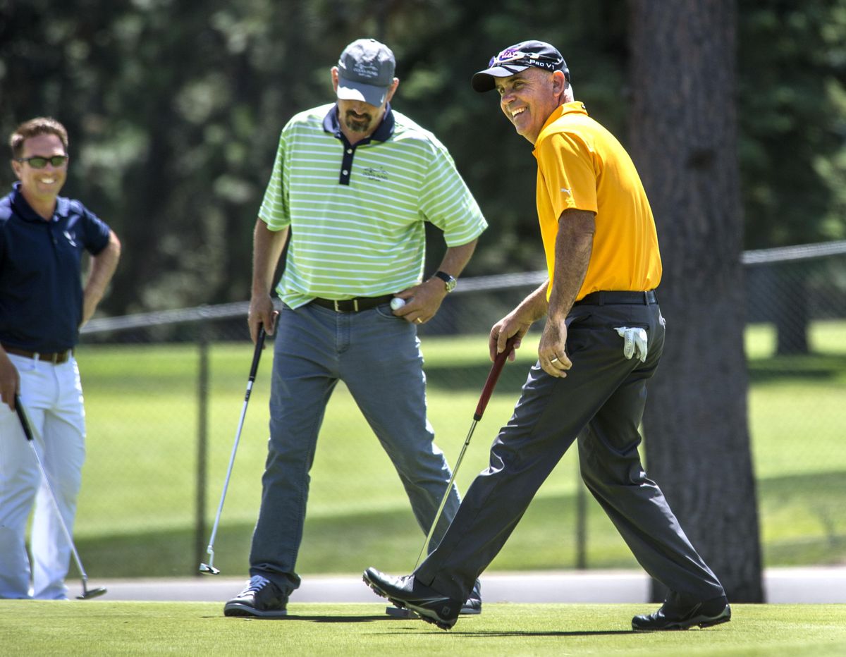 Chris Curran, right, is all smiles after sinking a putt on MeadowWood Golf Course’s 18th hole Friday during the first round of the Rosauers Open Invitational. (Dan Pelle / The Spokesman-Review)