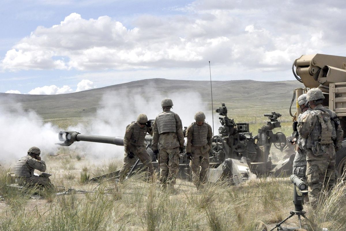 Members of Bravo Battery, 2nd Battalion 146th Field Artillery, fire their M77A2 Howitzers at the Yakima Training Center. (Jim Camden / The Spokesman-Review)
