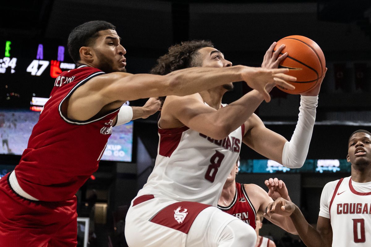 Washington State guard Nate Calmese (8) heads to the basket as Eastern Washington guard Nic McClain (11) defends during the second half of a NCAA college basketball game, Thursday, Nov. 21, 2024, at the Spokane Veterans Arena.  (COLIN MULVANY)