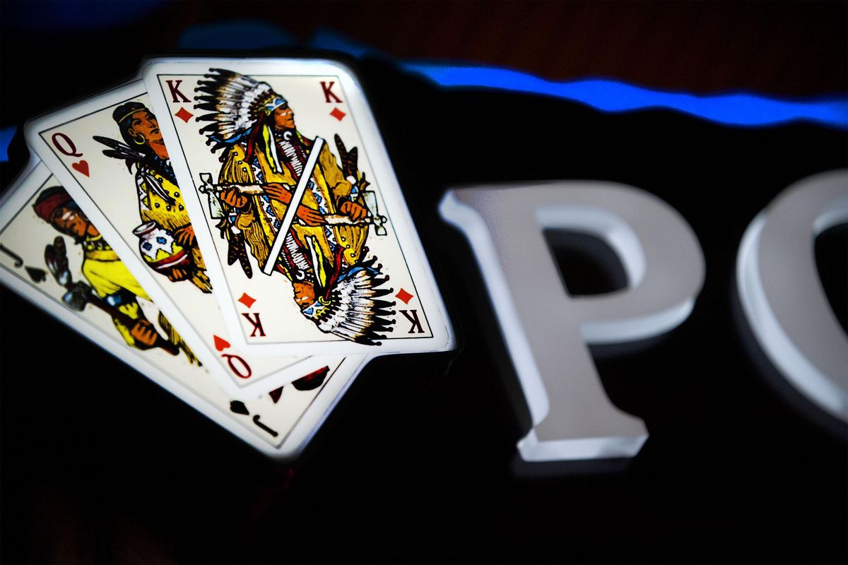 Part of the new poker room sign is illuminated at Coeur d’Alene Casino Resort and Hotel in Worley, Idaho, on Monday, April 14, 2014. (Kathy Plonka / The Spokesman-Review)