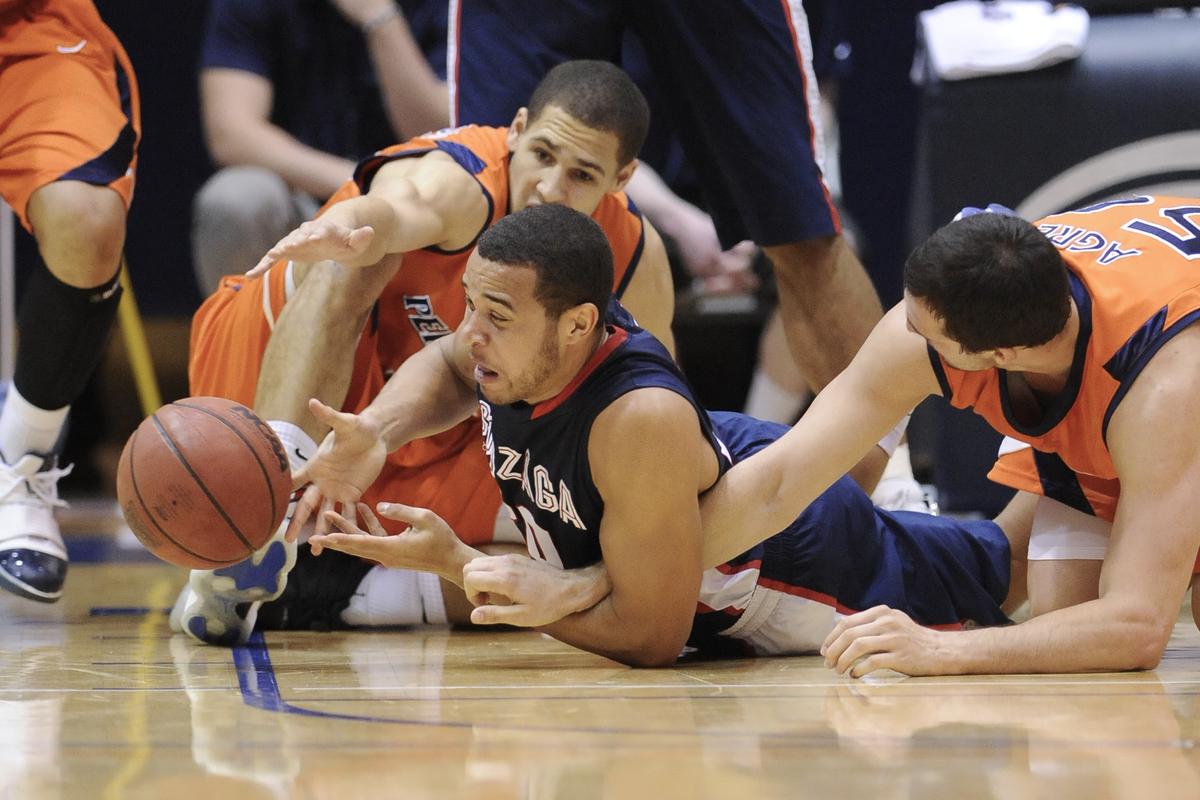 Gonzaga forward Elias Harris, center, fights for a loose ball with Pepperdine forward Mychel Thompson, left, and center Denis Agre during the first half Saturday, Feb. 20, 2010, in Malibu, Calif. (Gus Ruelas / Associated Press)