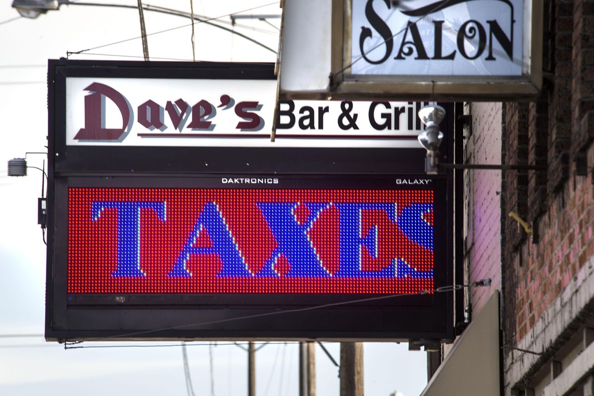 The sign on Dave’s Bar & Grill reads “Dear city, you promised no utility taxes. Please keep your promise.” (Dan Pelle / The Spokesman-Review)