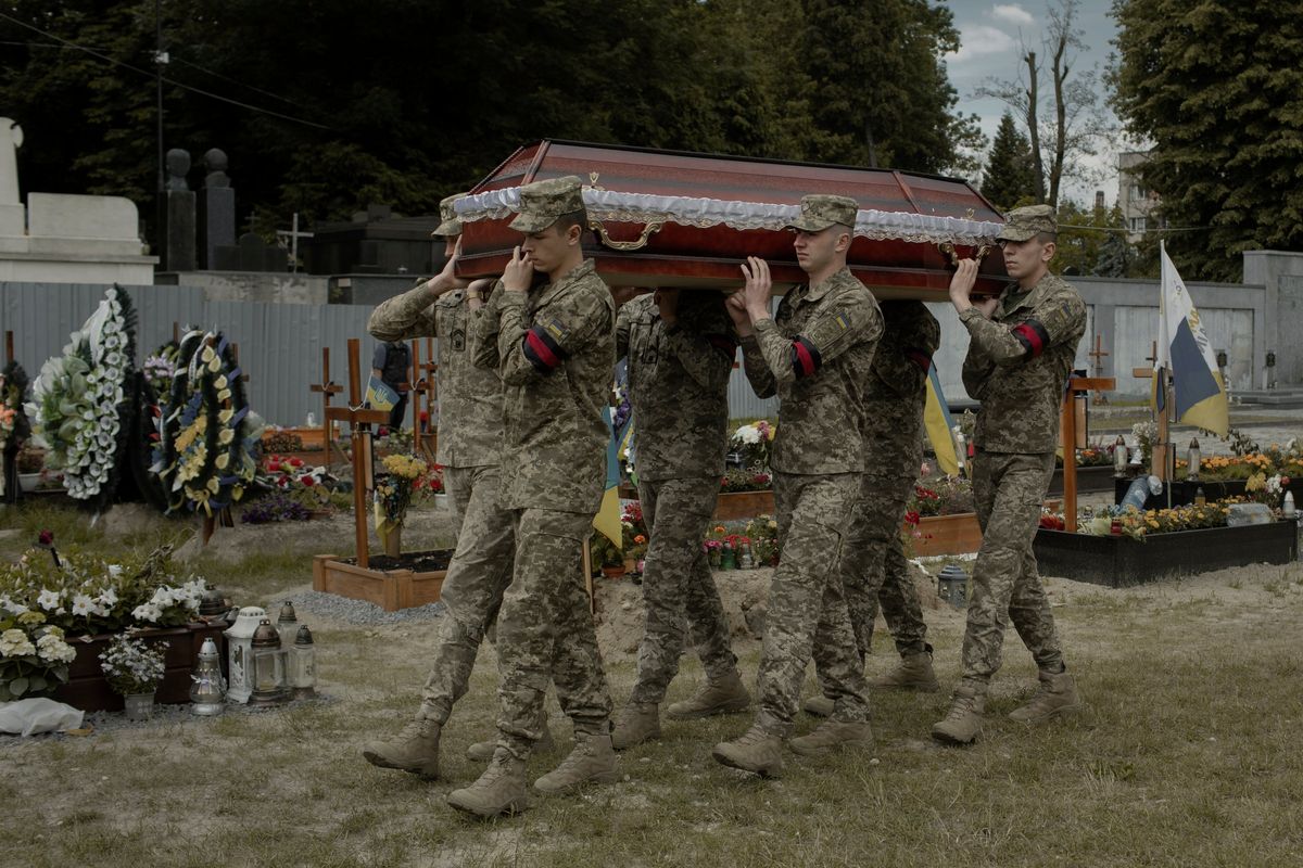 Soldiers carry the coffin of fallen Ukrainian soldier Yurii Brukhal, killed in fierce fighting at the front, in Lviv, Ukraine, on June 14. Many of the fighters for Ukraine’s western territorial defense units were assigned benign tasks away from the fighting when they first joined. Then they were called to the front to fight.  (EMILE DUCKE)