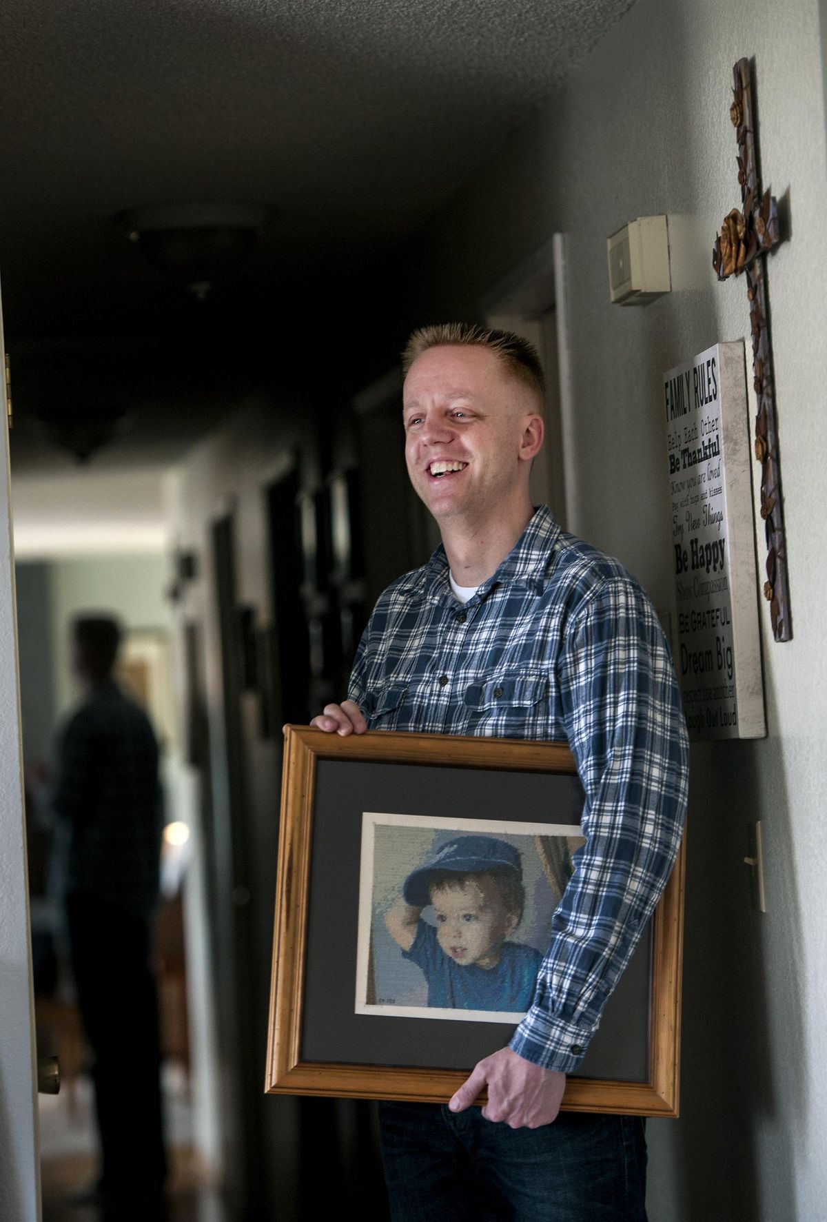 Eric Miller, of Otis Orchards, Wash., talks about his needlepoint hobby at his home in Otis Orchards on Wednesday, Jan 17, 2018. One of the first cross-stitch portraits he did was of his son Micah who died in 2003. He said it was a way to honor his son’s memory. (Kathy Plonka / The Spokesman-Review)