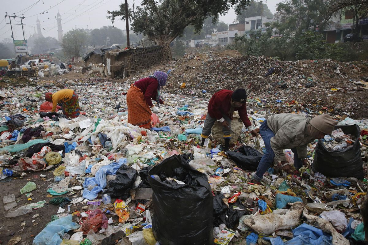 In this Jan. 21, 2016, file photo, Indian rag pickers look for reusable materials at a garbage dump littered with polythene bags in Lucknow, India. A new massive study finds that production of plastic and the hard-to-breakdown synthetic waste is soaring in huge numbers. The study says since 1950, industry has made more than 9 billion tons of plastics. That’s enough to cover the entire country of Argentina ankle-deep in the stuff. (Rajesh Kumar Singh / Associated Press)