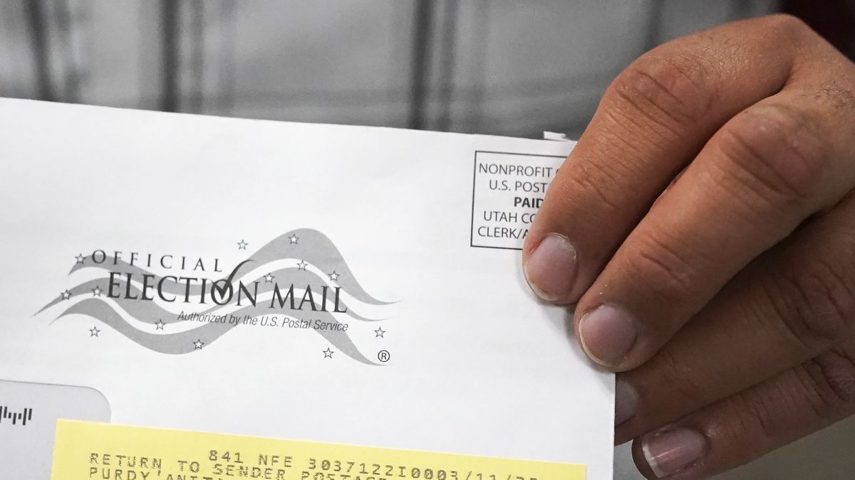 A election worker holds an election envelope during a tour of Utah County's elections equipment and review processes for administering secure elections Tuesday, April 19, 2022, in Provo, Utah. In Utah and other Republican-led states, unsubstantiated election fraud claims have upended support for vote by-mail, a practice that not long ago was overwhelmingly popular among Republicans.  (Rick Bowmer)