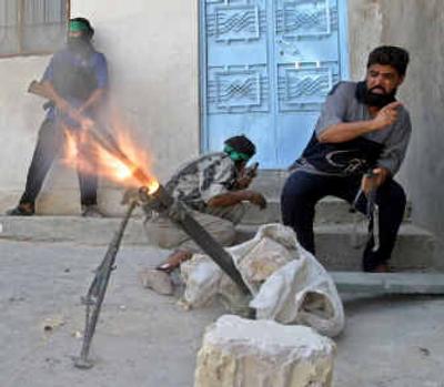 
Militiamen loyal to radical Iraqi Shiite cleric Muqtada al-Sadr fire a mortar Monday in the city of Najaf, Iraq. Hundreds have died in fighting that began Thursday.
 (Reuters / The Spokesman-Review)