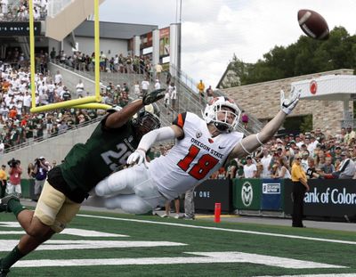 Oregon State wide receiver Timmy Hernandez, right, reaches out for a pass but misses the ball as Colorado State defensive back Justin Sweet defends during the first half of Saturday’s game. Colorado State won 58-27. (David Zalubowski / Associated Press)