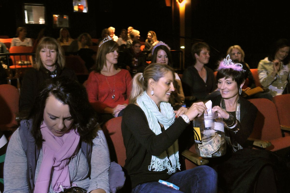 Angie Phillips, center, and Michele Dirks, right, make their donations to a charity during a birthday club monthly gathering Feb. 19 at the Magic Lantern Theatre. Instead of buying gifts, the women donate to a cause. Women celebrating birthdays are given tiaras. (PHOTOS BY JESSE TINSLEY)