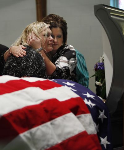 Tiffany Ellis, left, is comforted  during a funeral service for her grandfather, Benny Ray Willingham, in Mullens, W.Va., on Friday. Willingham was among those killed in the explosion at the Upper Big Branch Mine.  (Associated Press)
