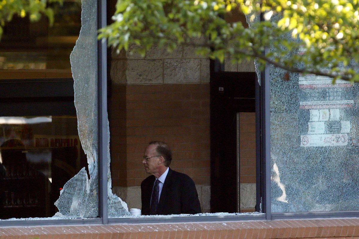 Middlesex County prosecutor Bruce Kaplan is seen through two broken windows as he arrives at the scene of a shooting at a Pathmark grocery store in Old Bridge, N.J., Friday, Aug. 31, 2012. At least three people have died in the shooting. A law enforcement official briefed on the shooting says the person believed to be the shooter is among the dead. (Julio Cortez / Associated Press)