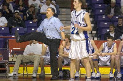 
Wilbur-Creston coach Tom Johnson tries a little body English to encourage a shot to go Friday.
 (Christopher Anderson / The Spokesman-Review)