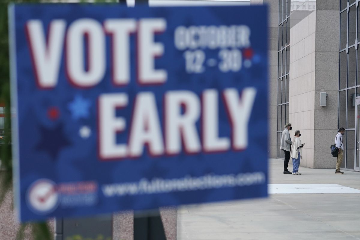 A line forms outside of the State Farm Arena for early voting on Monday, Oct. 12, 2020, in Atlanta. (Brynn Anderson)