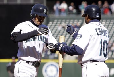 Seattle’s Endy Chavez, right, congratulates Ichiro Suzuki after his first-inning homer provided the lone run during Thursday’s game.  (Associated Press / The Spokesman-Review)