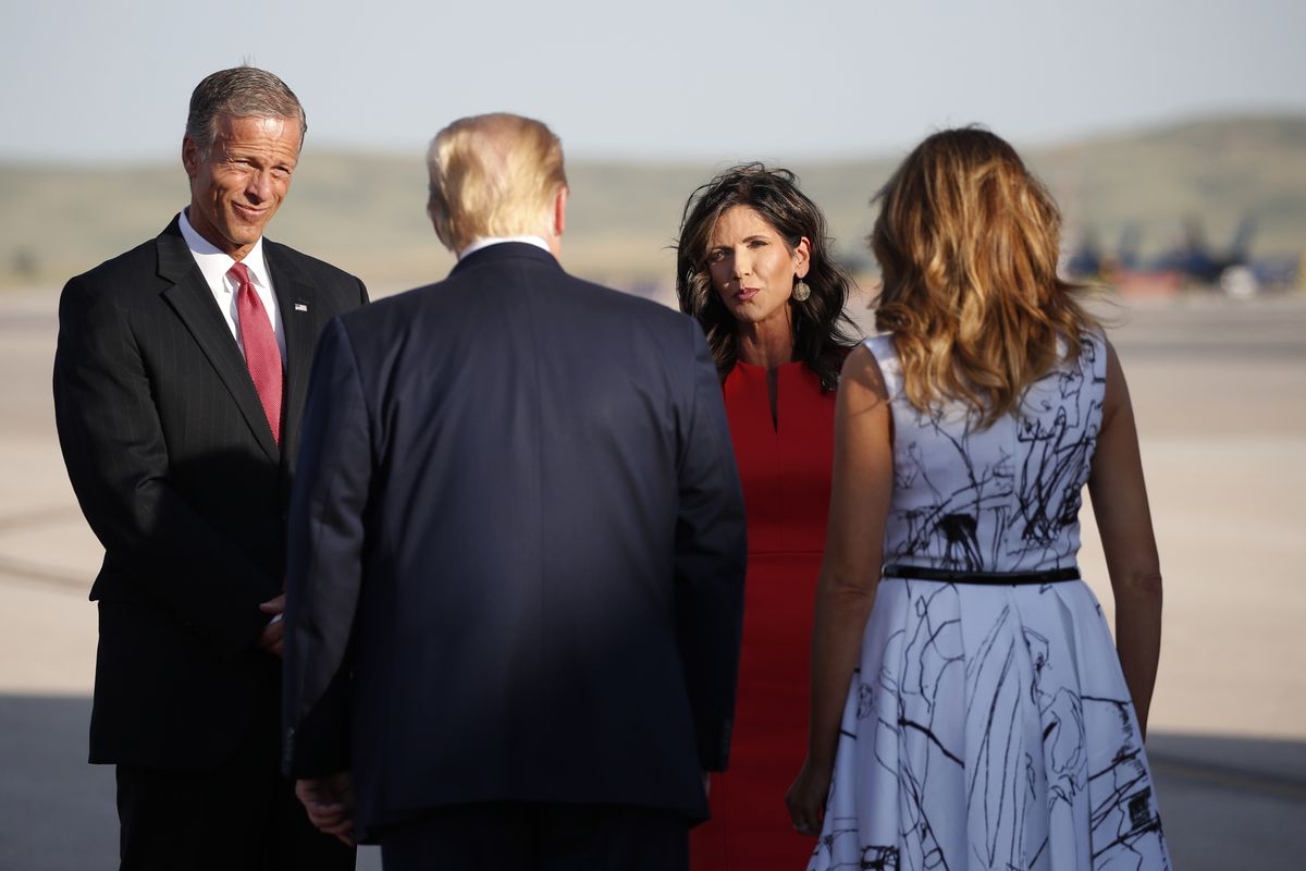 FILE - In this July 3, 2020 file photo, Sen. John Thune, R-S.D., and Gov. Kristi Noem greet President Donald Trump and first lady Melania Trump upon arrival at Ellsworth Air Force Base, in Rapid City, S.D. State officials say they plan to erect a security fence around the official governor