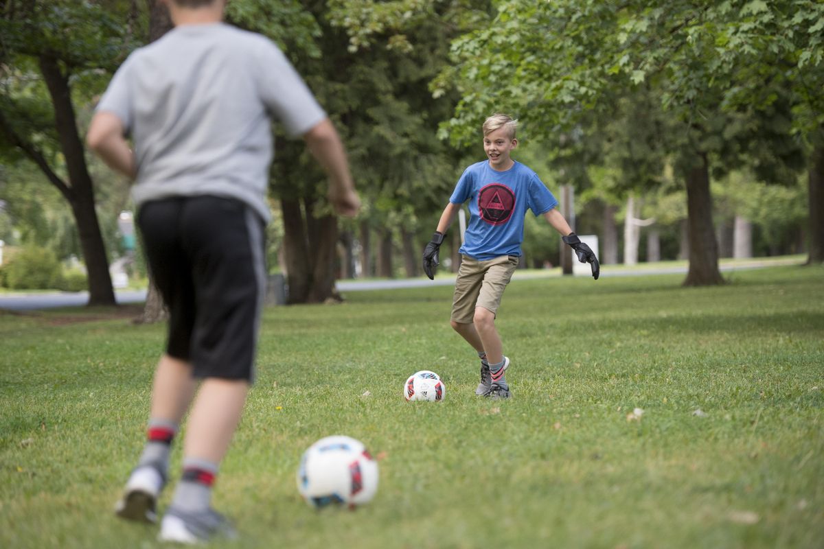 Nolan Stewart plays soccer with his younger brother, Elliot, at their home on Friday, Sept. 2, 2016, in Spokane. Nolan Stewart was diagnosed with Crohn