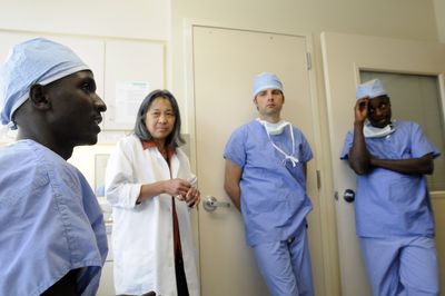 Drs. Dan Rudasingwa, left, and Aflodis Kagaba, far right, of Rwanda, talk about their experiences visiting Deaconess Medical Center Friday with Dr. Pam Silverstein and premedical student John Holbrook.  (Jesse Tinsley / The Spokesman-Review)