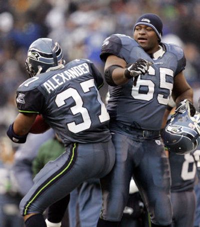 Seattle's Chris Spencer helps teammate Shaun Alexander celebrate his third-quarter touchdown run. Alexander has 23 touchdowns this season.
(Associated Press / The Spokesman-Review)