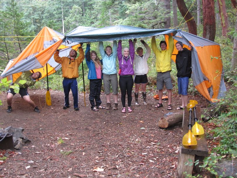 Western Washington University students out for an overnight sea-kayaking trip to Lummi Island improvise a group shelter out of ground cloths and tent rain flies after they realized they'd forgotten the poles to their tents. (Hillary Landers)