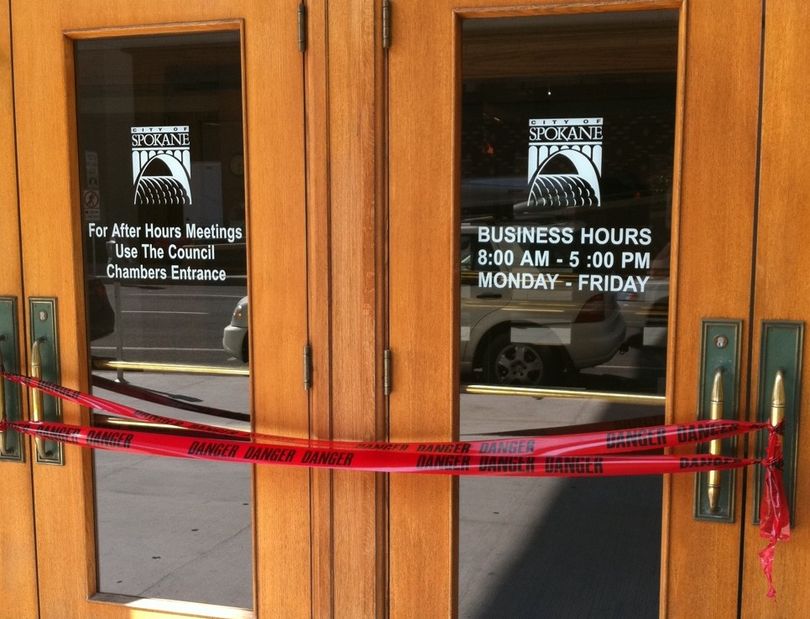 Doors at Spokane City Hall were wrapped with tape warning danger on August 16, 2010 soon after officials decided to close the building to the public while firefighters determined if white powder found inside was dangerous. The building closed before 3:30 p.m. and reopened about an hour later.