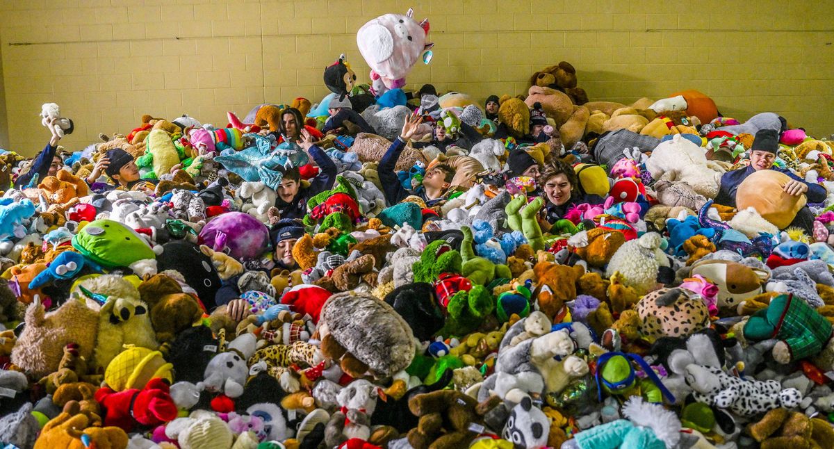 Several members of the Spokane Chiefs hockey team hide in a huge pile of donated teddy bears and stuffed animals while delivering the toys to the Christmas Bureau at the Spokane County Fair and Expo Center on Monday.  (Kathy Plonka/The Spokesman-Review)
