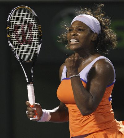 Serena Williams celebrates after defeating her sister Venus in three sets.  (Associated Press / The Spokesman-Review)