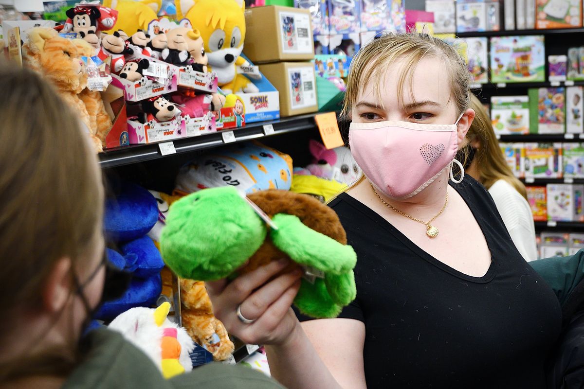 Clarissa Richards wags a stuffed turtle in her sister Lillian’s face Friday while doing Christmas shopping at The General Store in Spokane.  (COLIN TIERNAN/THE SPOKESMAN-REVIEW)