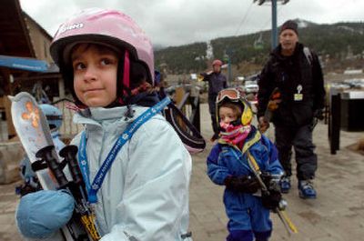 
Kyra Devore, 8, left, and her sister, Kenna, 5, head to the Silver Mountain gondola at Kellogg on Saturday with family and friends. 
 (Photos by Jesse Tinsley / The Spokesman-Review)